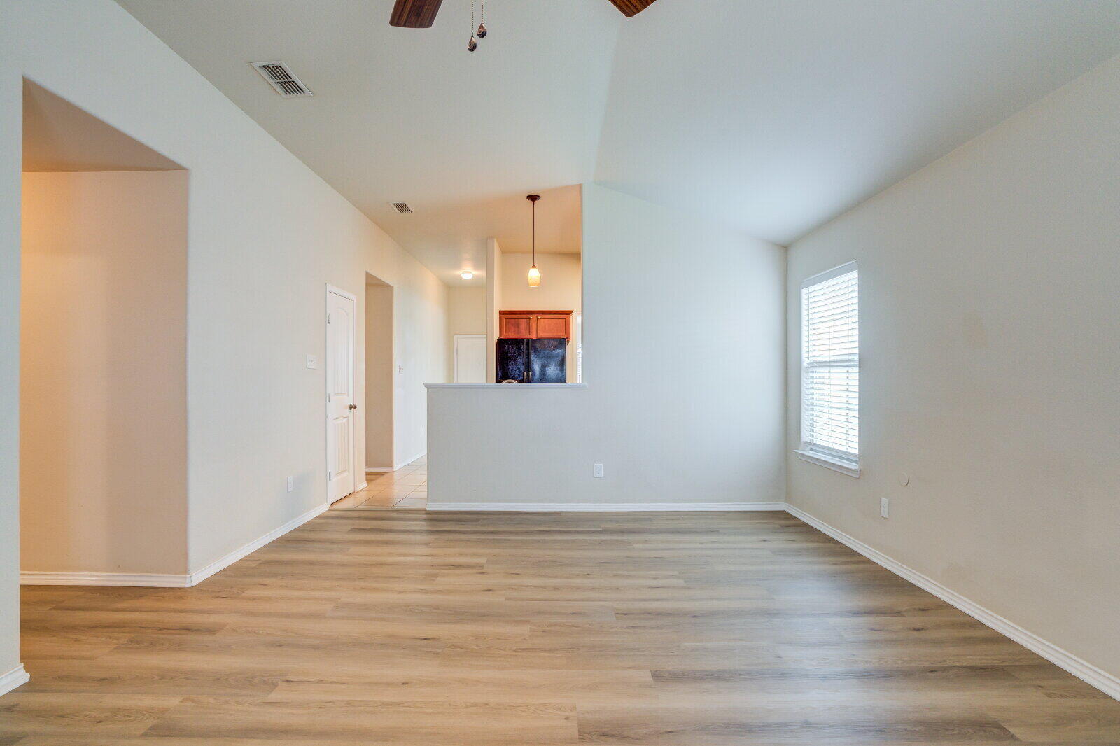 6921 95th Street Lubbock, TX 79424 - Photo 16 of 32 an empty room with wooden floor and windows
