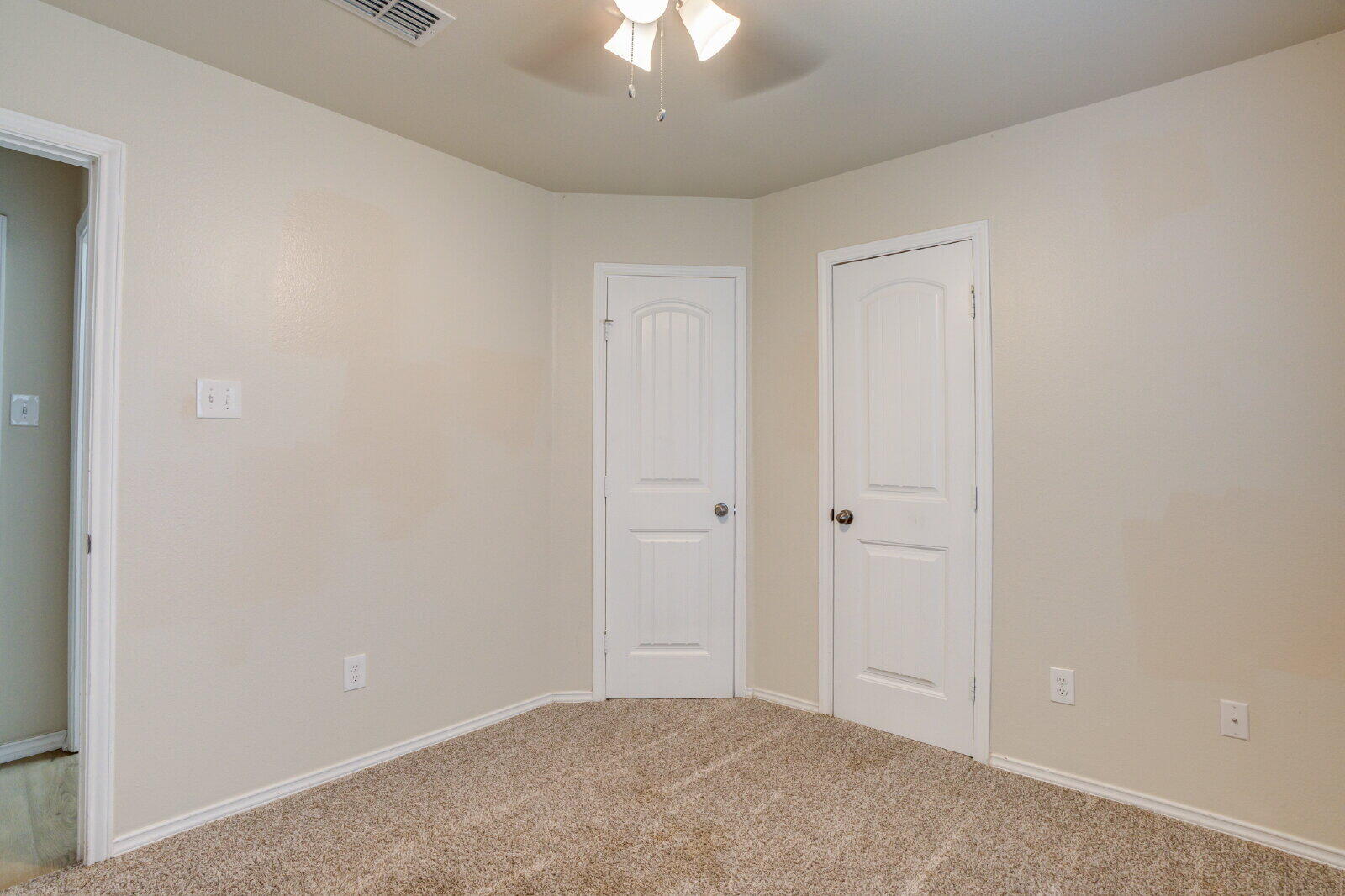 6921 95th Street Lubbock, TX 79424 - Photo 20 of 32 a view of an empty room and chandelier fan