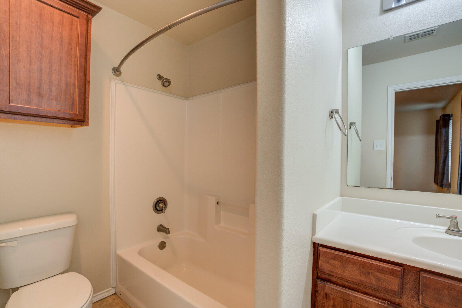 6921 95th Street Lubbock, TX 79424 - Photo 28 of 32 a bathroom with a sink a toilet and shower