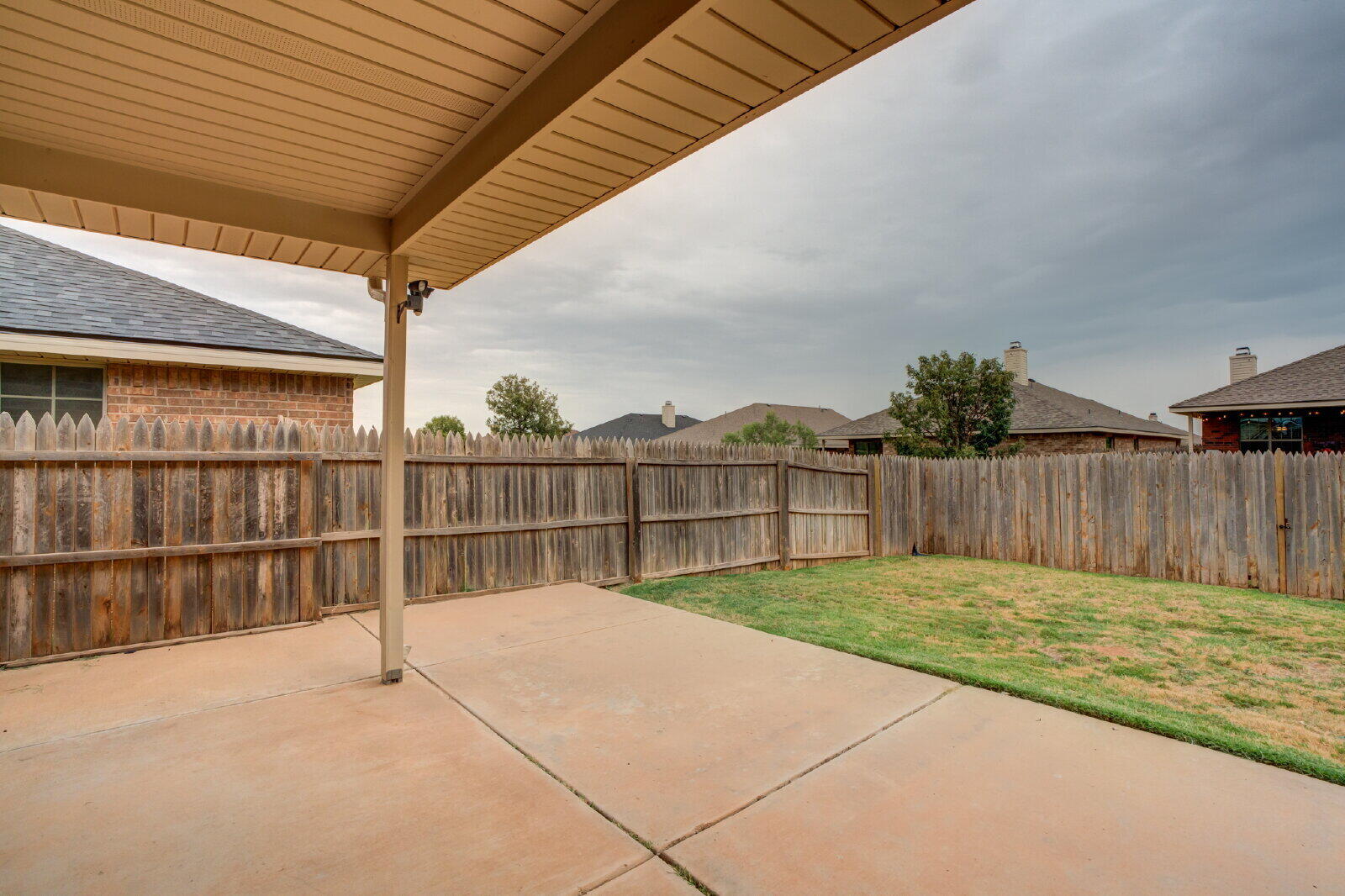 6921 95th Street Lubbock, TX 79424 - Photo 30 of 32 a view of backyard with wooden fence
