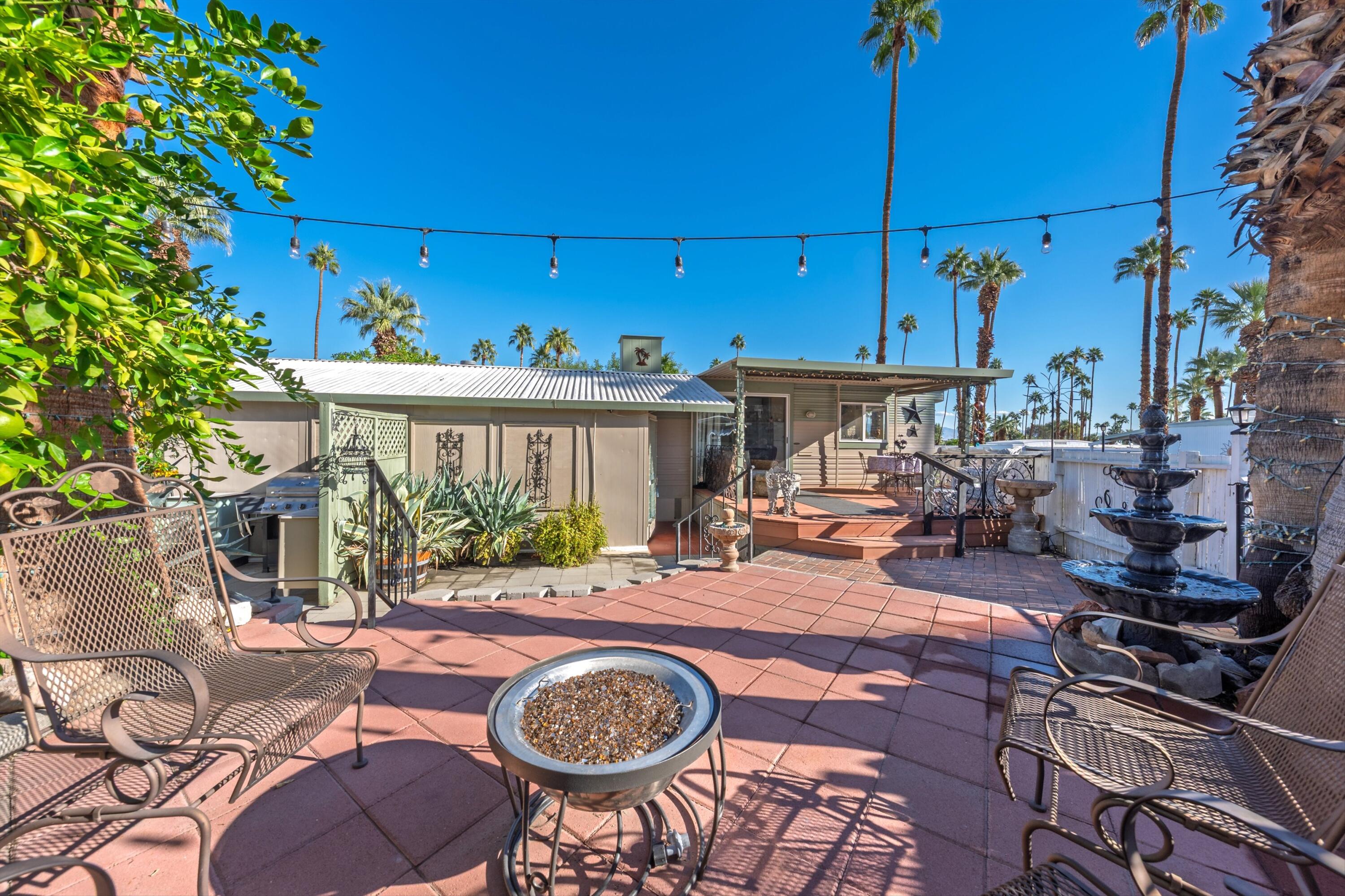 70260 Highway 111, Unit 42 Rancho Mirage, CA 92270 - Photo 13 of 35 a view of a patio with table and chairs under an umbrella