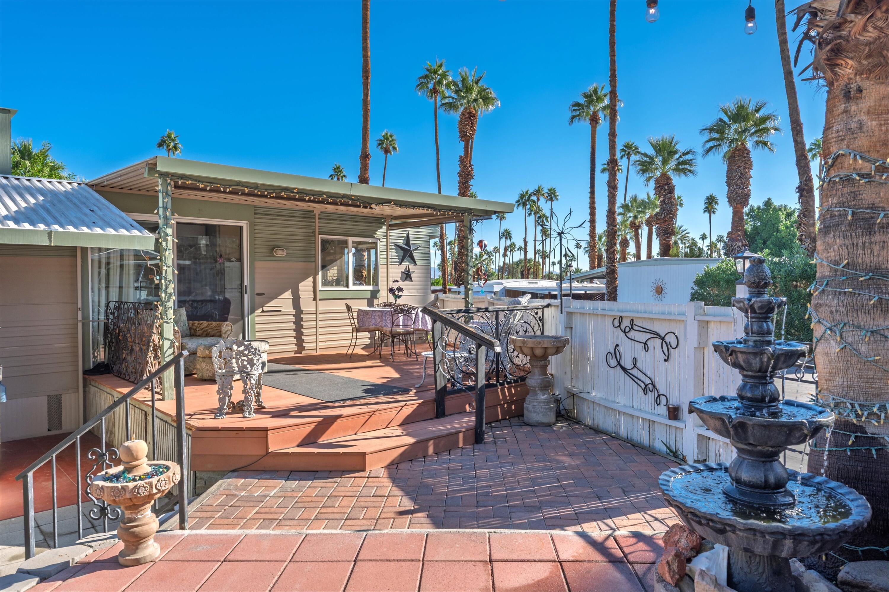 70260 Highway 111, Unit 42 Rancho Mirage, CA 92270 - Photo 14 of 35 a view of a patio with a table and chairs