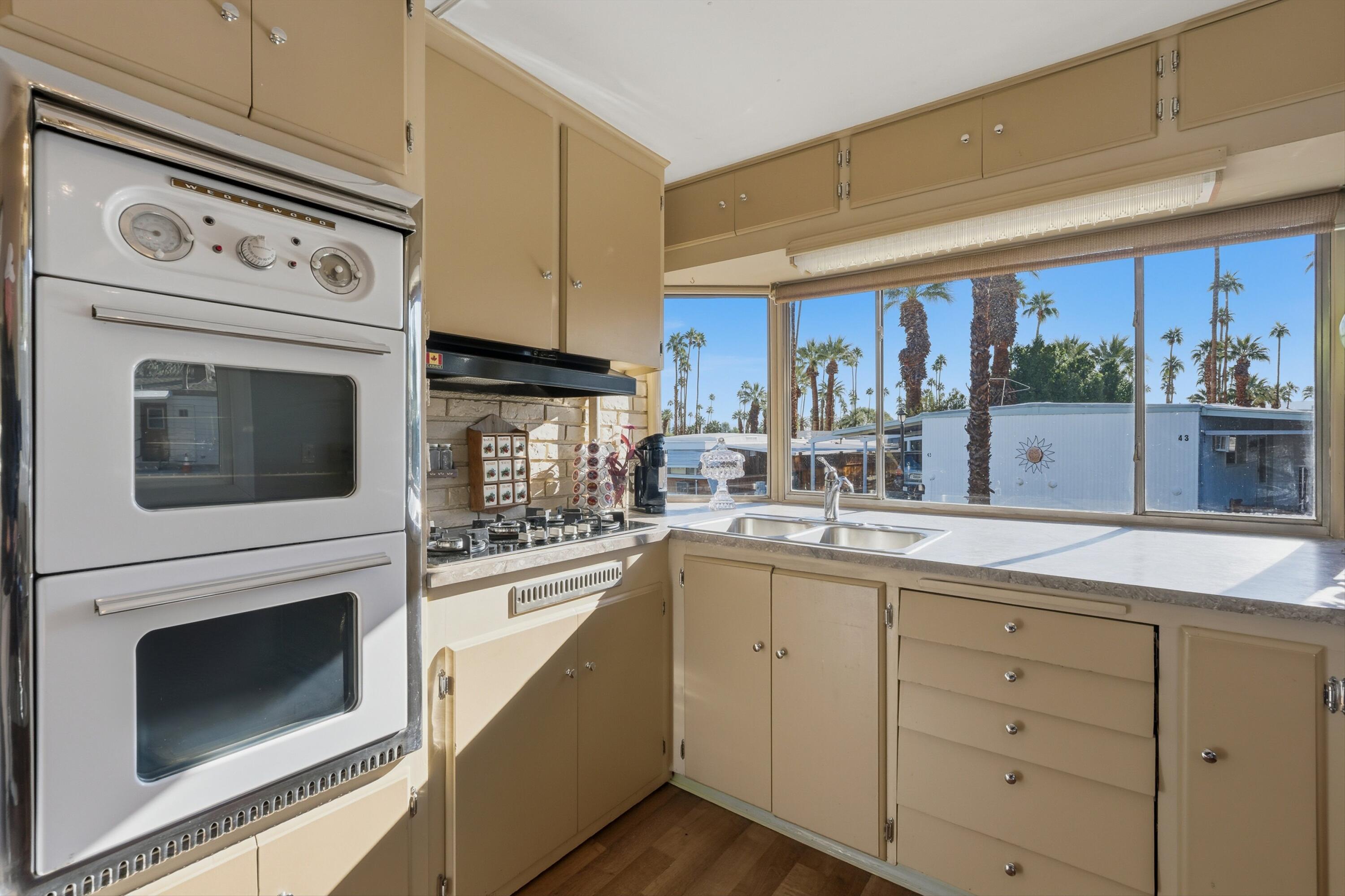 70260 Highway 111, Unit 42 Rancho Mirage, CA 92270 - Photo 20 of 35 a kitchen with cabinets stainless steel appliances a sink and a window