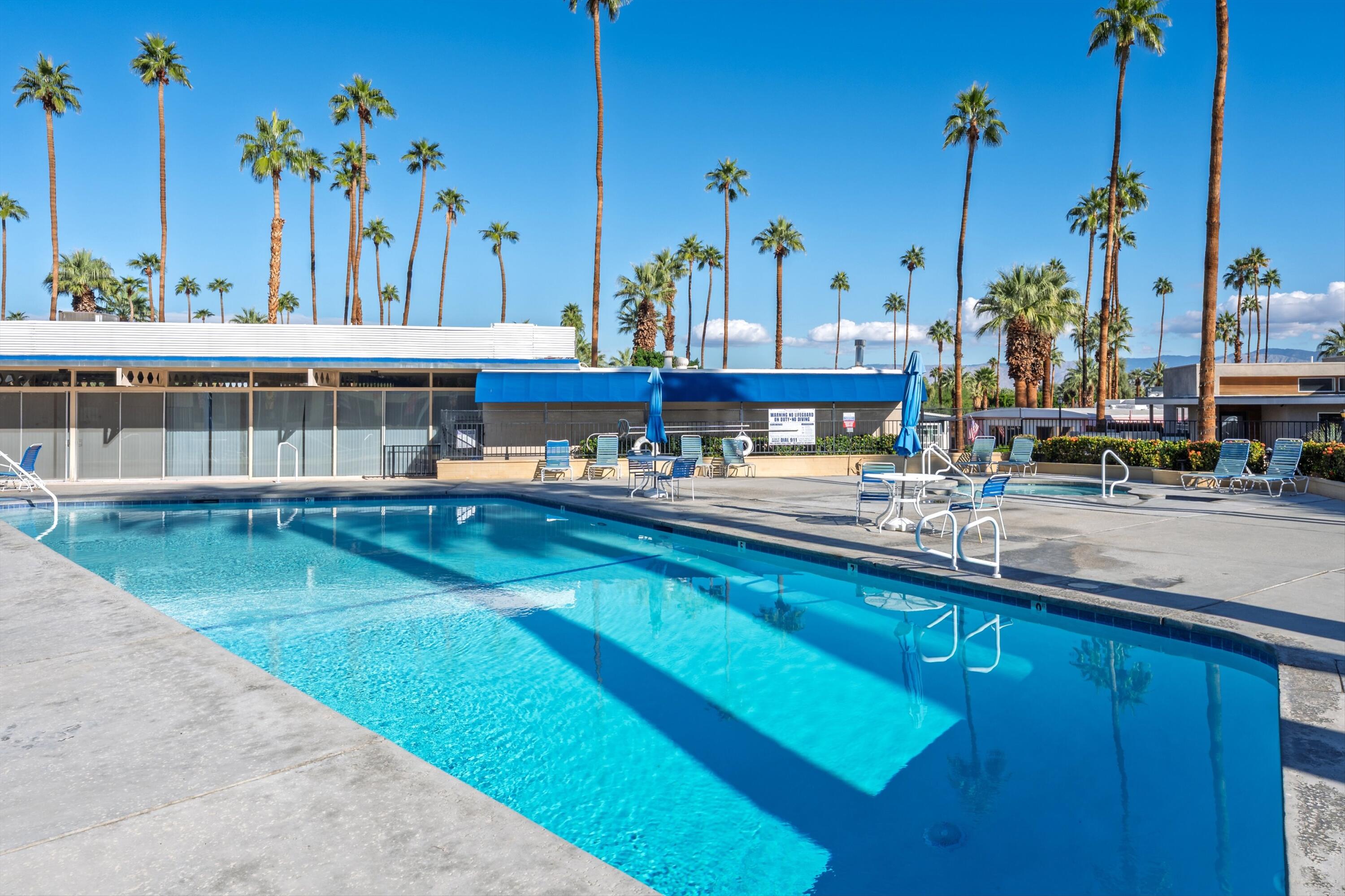 70260 Highway 111, Unit 42 Rancho Mirage, CA 92270 - Photo 32 of 35 a view of a swimming pool with outdoor seating