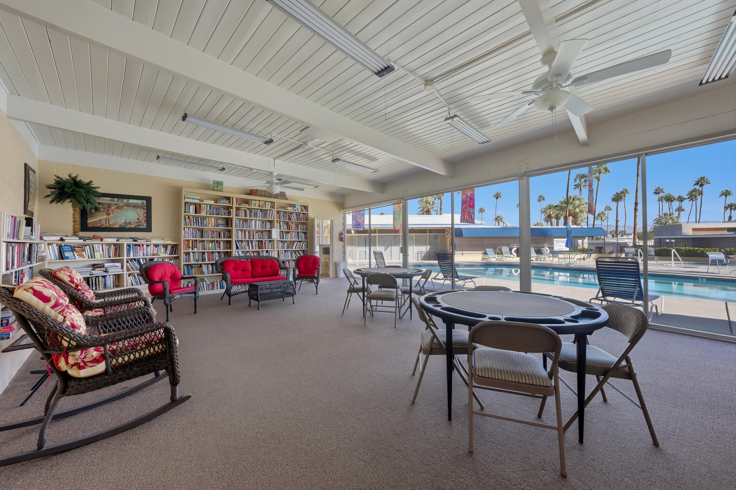 70260 Highway 111, Unit 42 Rancho Mirage, CA 92270 - Photo 35 of 35 a living room with furniture a pool table and a fireplace