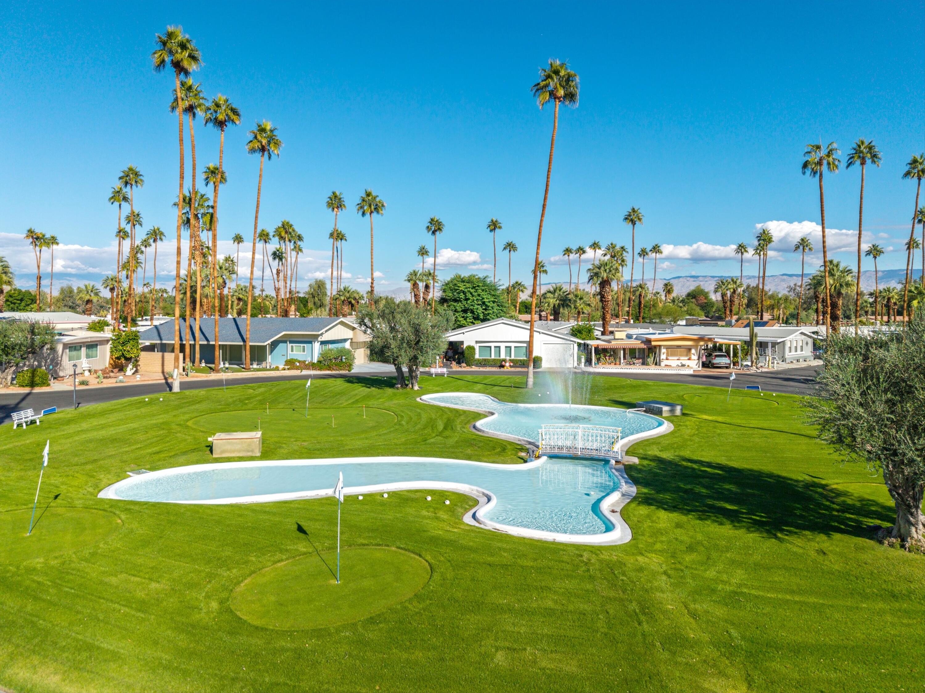 70260 Highway 111, Unit 42 Rancho Mirage, CA 92270 - Photo 5 of 35 a view of a swimming pool with a yard