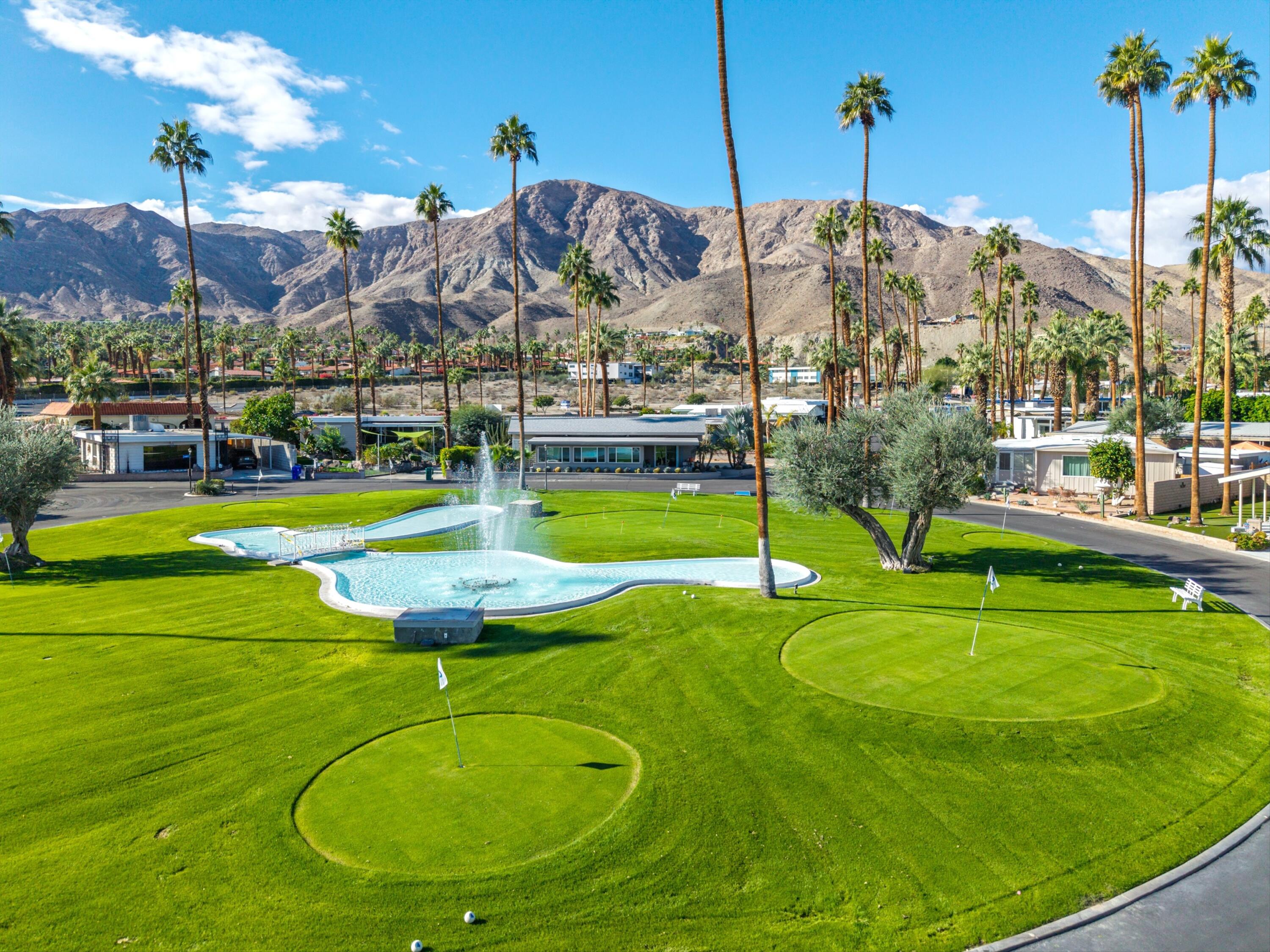 70260 Highway 111, Unit 42 Rancho Mirage, CA 92270 - Photo 6 of 35 a view of a swimming pool with a yard