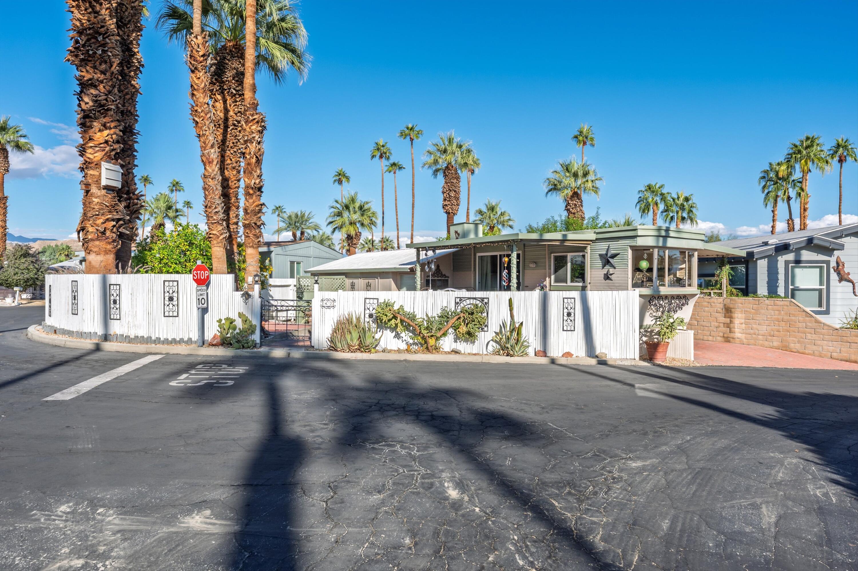 70260 Highway 111, Unit 42 Rancho Mirage, CA 92270 - Photo 8 of 35 a view of a house with a yard and potted plants