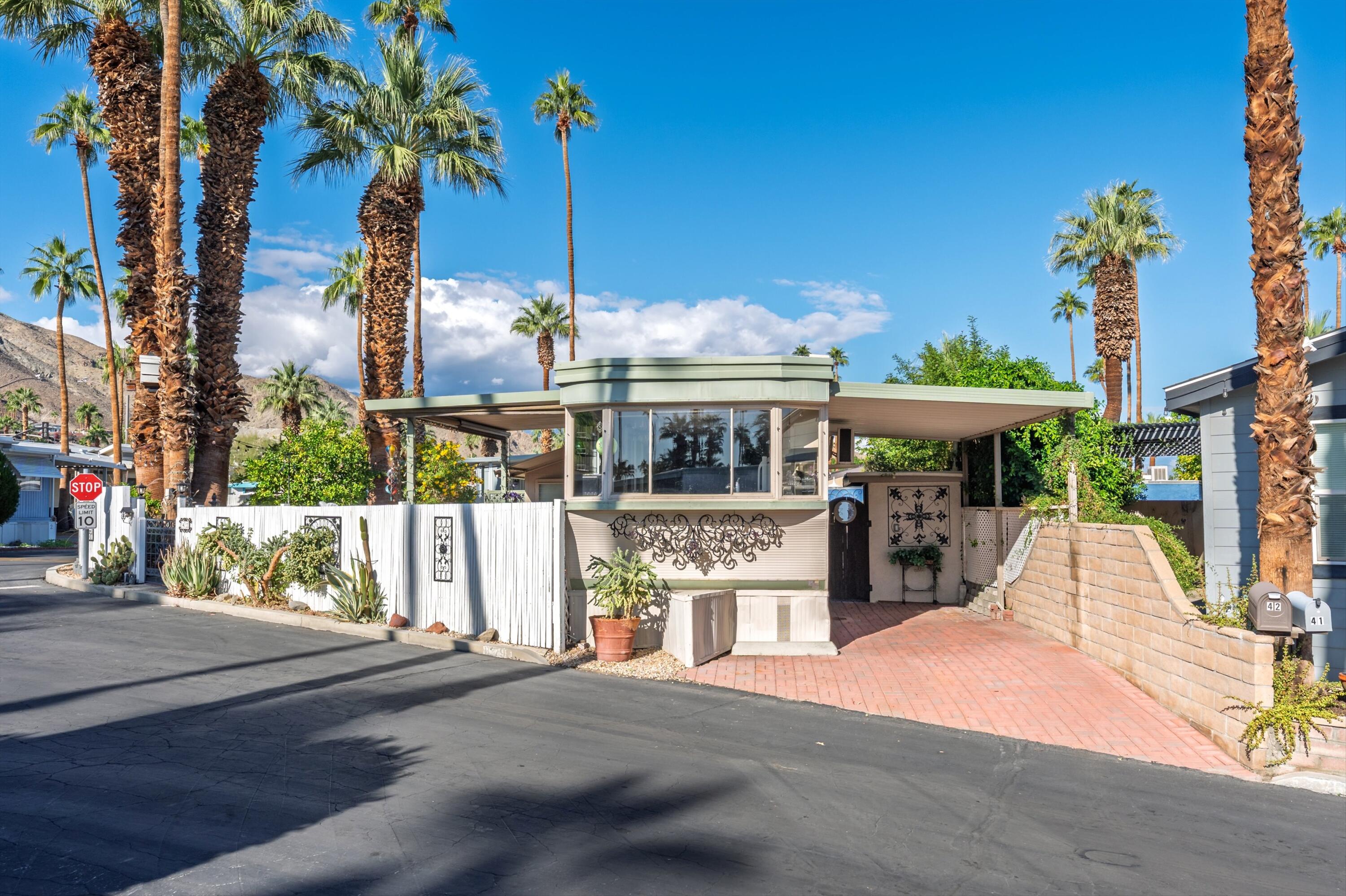 70260 Highway 111, Unit 42 Rancho Mirage, CA 92270 - Photo 9 of 35 a front view of house with a garden