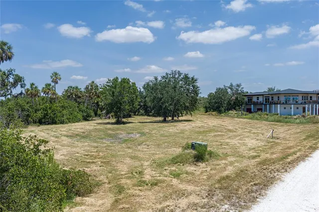 a swimming pool with an outdoor seating and trees in the background