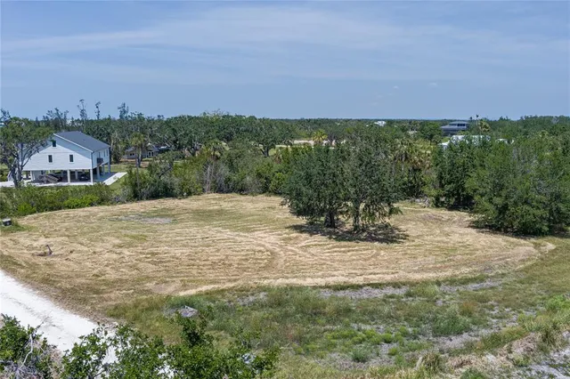 a view of a big yard with a house in the background