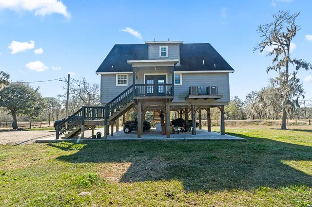 a view of dirt yard with large trees