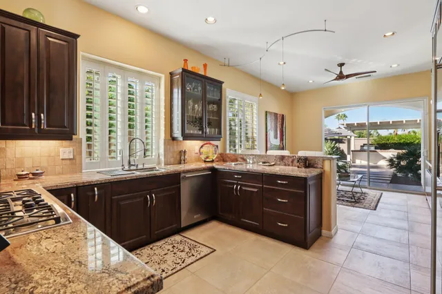 a bedroom with a bed lamp and a chandelier