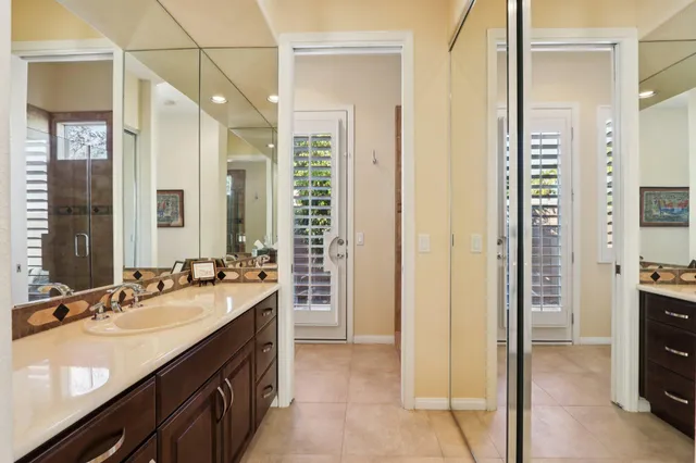 a view of a patio with couches table and chairs and potted plants