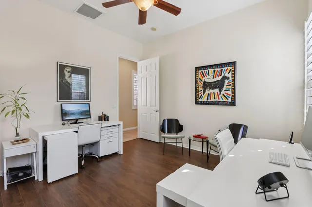 a view of a house with a yard and potted plants