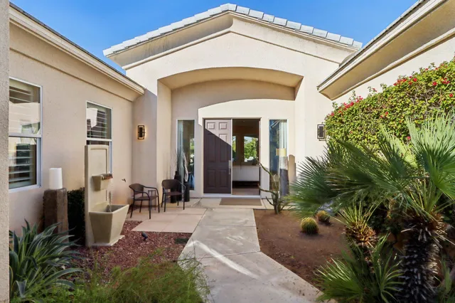 a view of a dining room with furniture and a large window
