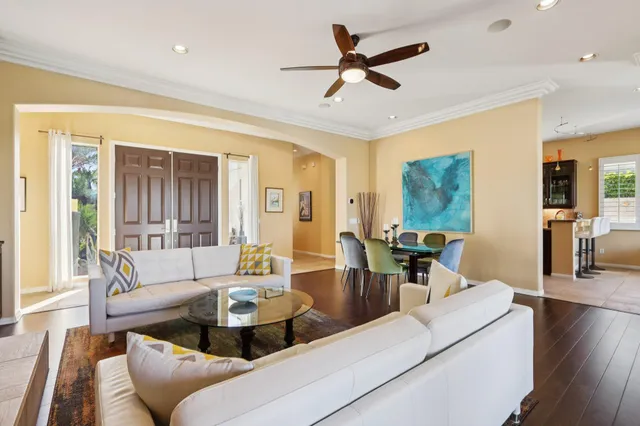 a living room with fireplace furniture and a large window