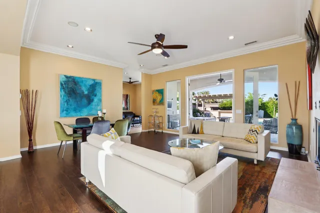 a living room with fireplace furniture and a large window