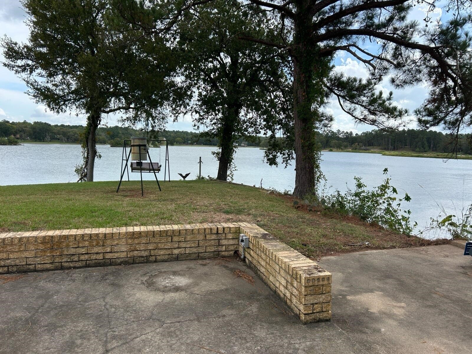 46 Point Loop Huntsville, TX 77320 - Photo 42 of 49 a view of a garden with a bench and trees