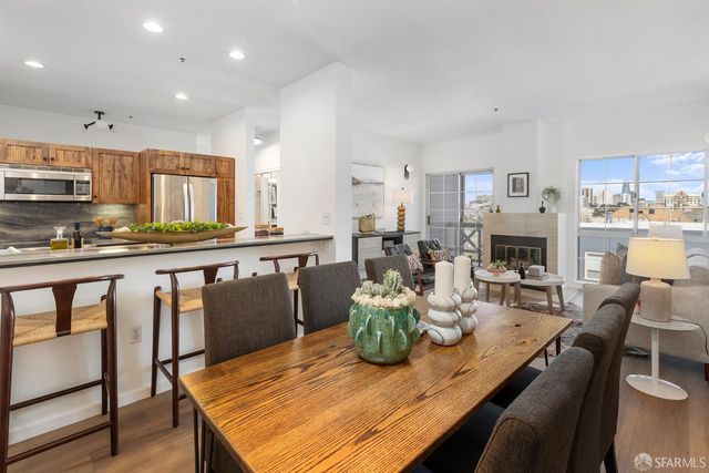 a living room with furniture a fireplace and a table
