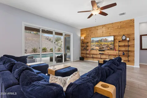 a kitchen with stainless steel appliances granite countertop a refrigerator a sink a stove and a wooden floors