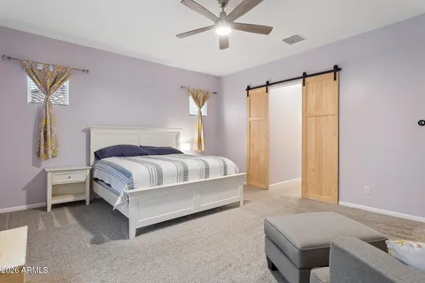 a bedroom with a bed couch and window