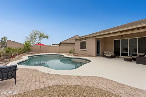 a view of a swimming pool with a yard