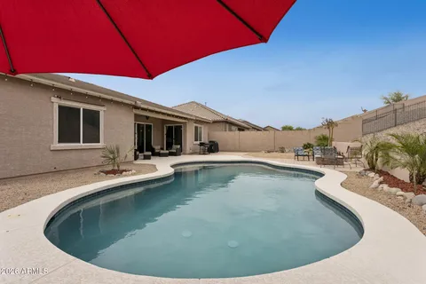 a backyard of a house with yard fire pit and outdoor seating