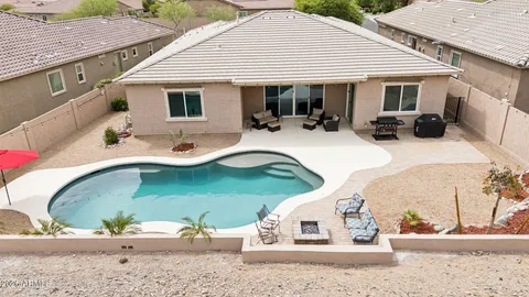 a aerial view of a house with a yard and potted plants