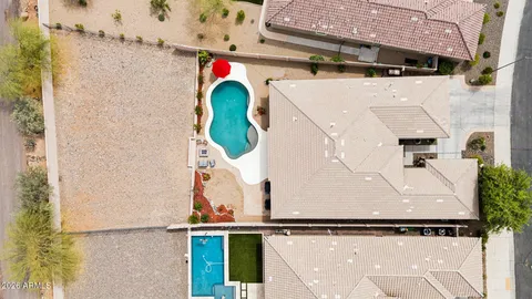 an aerial view of a house with swimming pool
