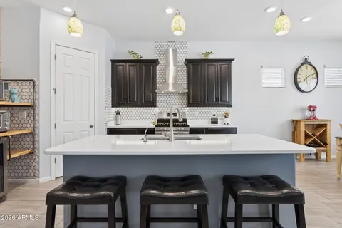 a kitchen with a sink stove and refrigerator