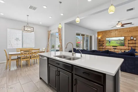 a kitchen with stainless steel appliances a sink and a refrigerator