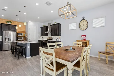 a kitchen with a table chairs sink and microwave