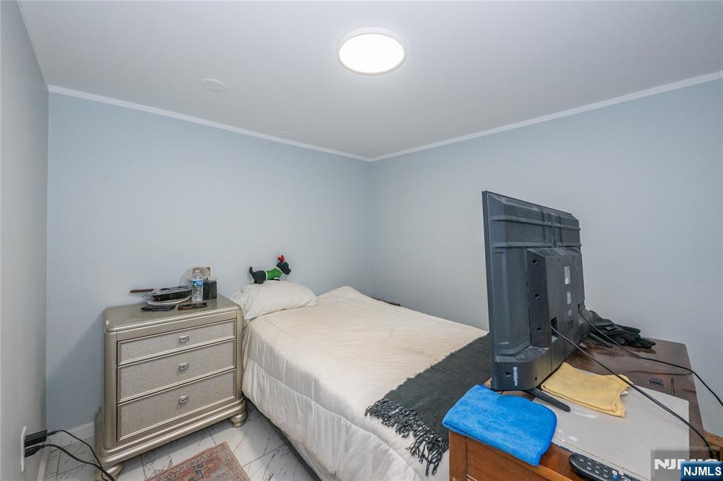 723 East 26th Street Paterson, NJ 07504 - Photo 15 of 41 a bedroom with a bed and a desk