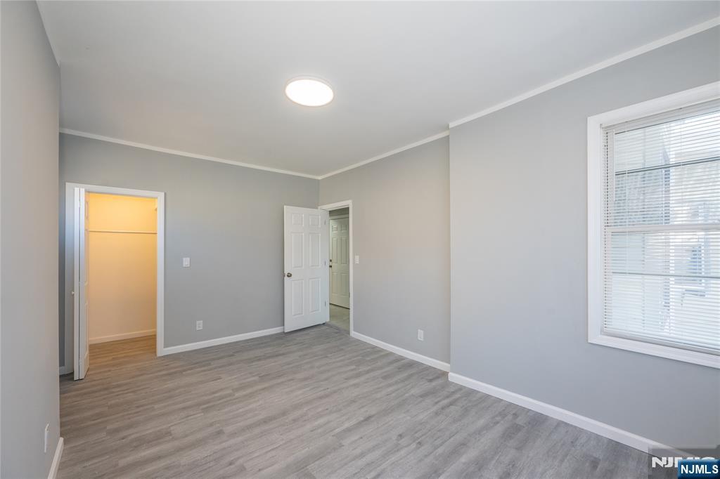 723 East 26th Street Paterson, NJ 07504 - Photo 20 of 41 a view of an empty room with wooden floor and a window