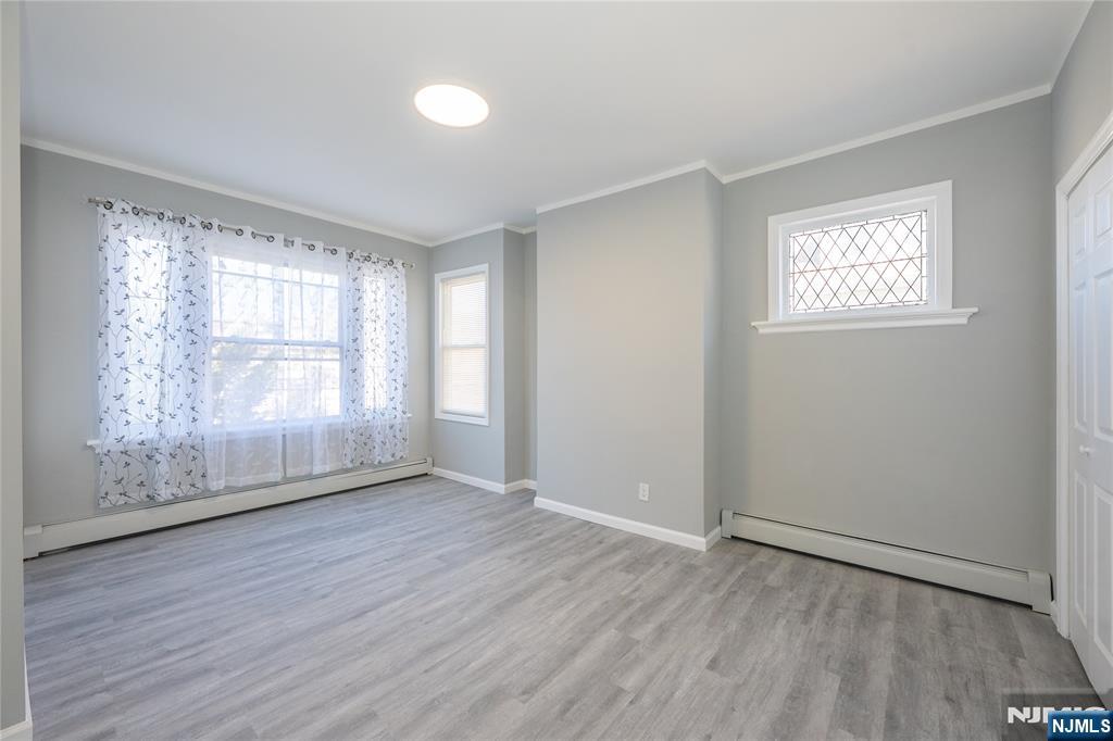 723 East 26th Street Paterson, NJ 07504 - Photo 21 of 41 an empty room with wooden floor and windows