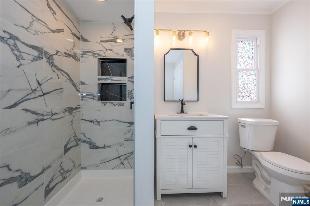 723 East 26th Street Paterson, NJ 07504 - Photo 26 of 41 a bathroom with a sink a toilet and mirror