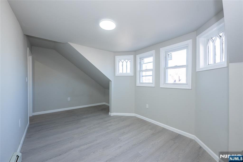 723 East 26th Street Paterson, NJ 07504 - Photo 33 of 41 an empty room with wooden floor and windows