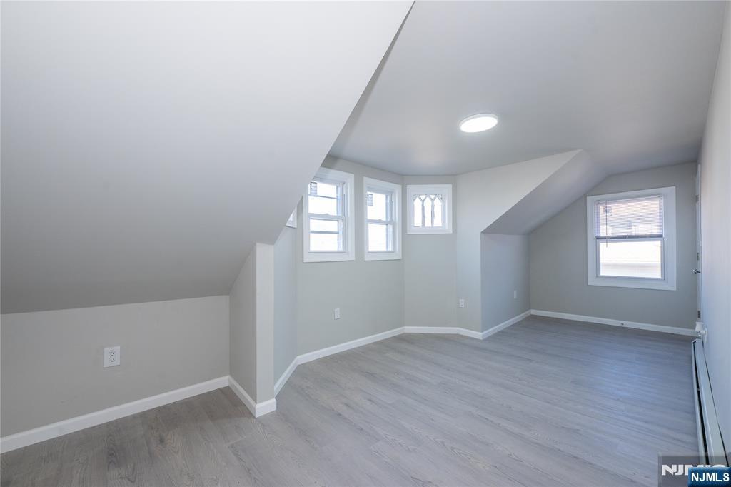 723 East 26th Street Paterson, NJ 07504 - Photo 34 of 41 an empty room with wooden floor and windows