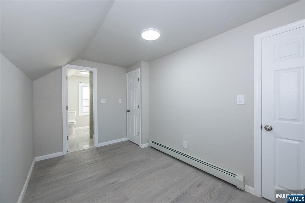 723 East 26th Street Paterson, NJ 07504 - Photo 38 of 41 an empty room with wooden floor and closet