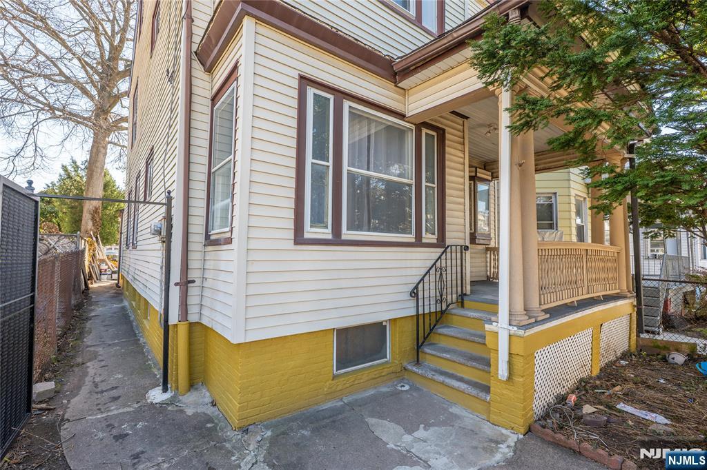 723 East 26th Street Paterson, NJ 07504 - Photo 40 of 41 a view of a house with large windows and wooden fence