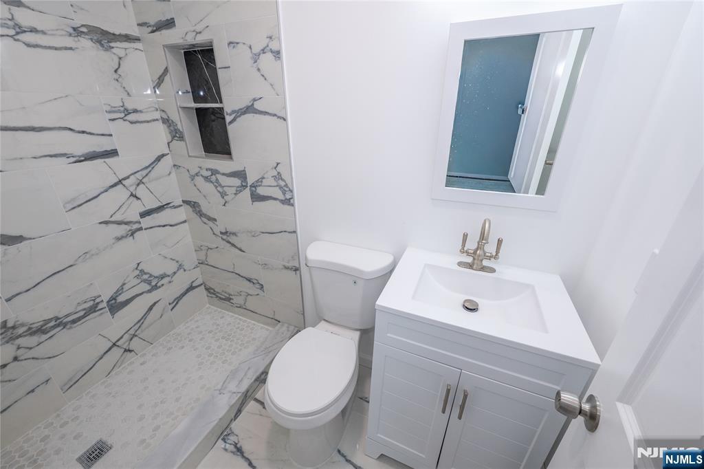 723 East 26th Street Paterson, NJ 07504 - Photo 7 of 41 a bathroom with a sink toilet and shower