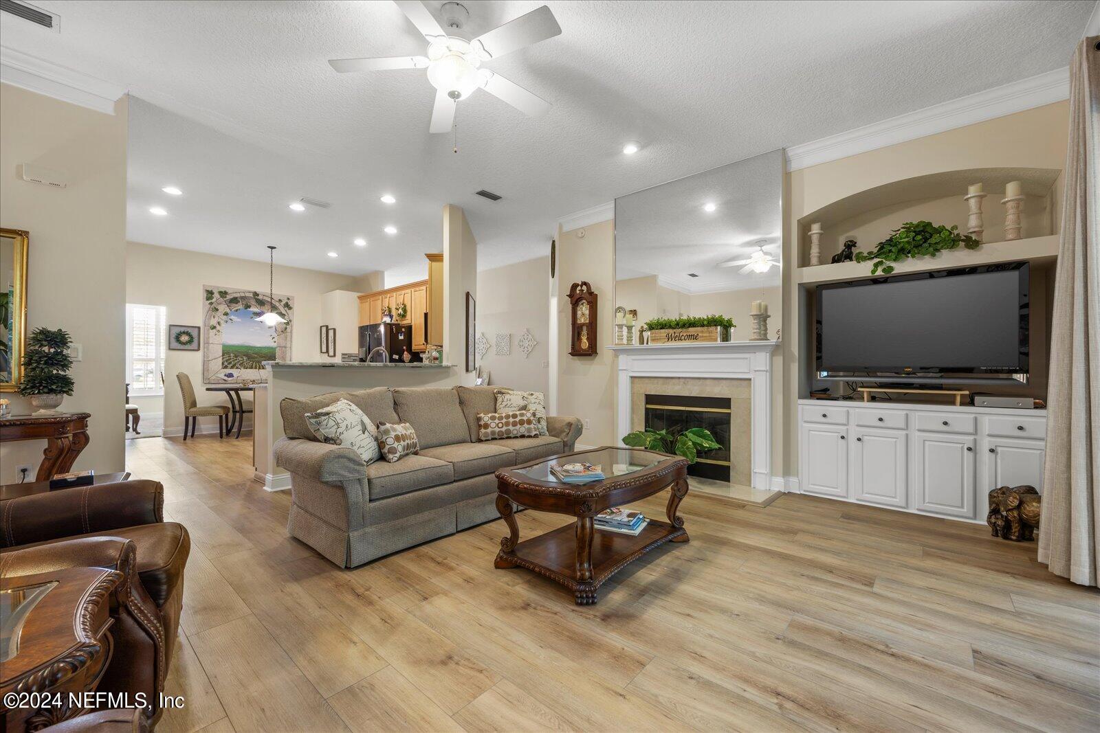 1283 Paradise Pond Road St. Augustine, FL 32092 - Photo 13 of 47 a living room with fireplace furniture and a flat screen tv
