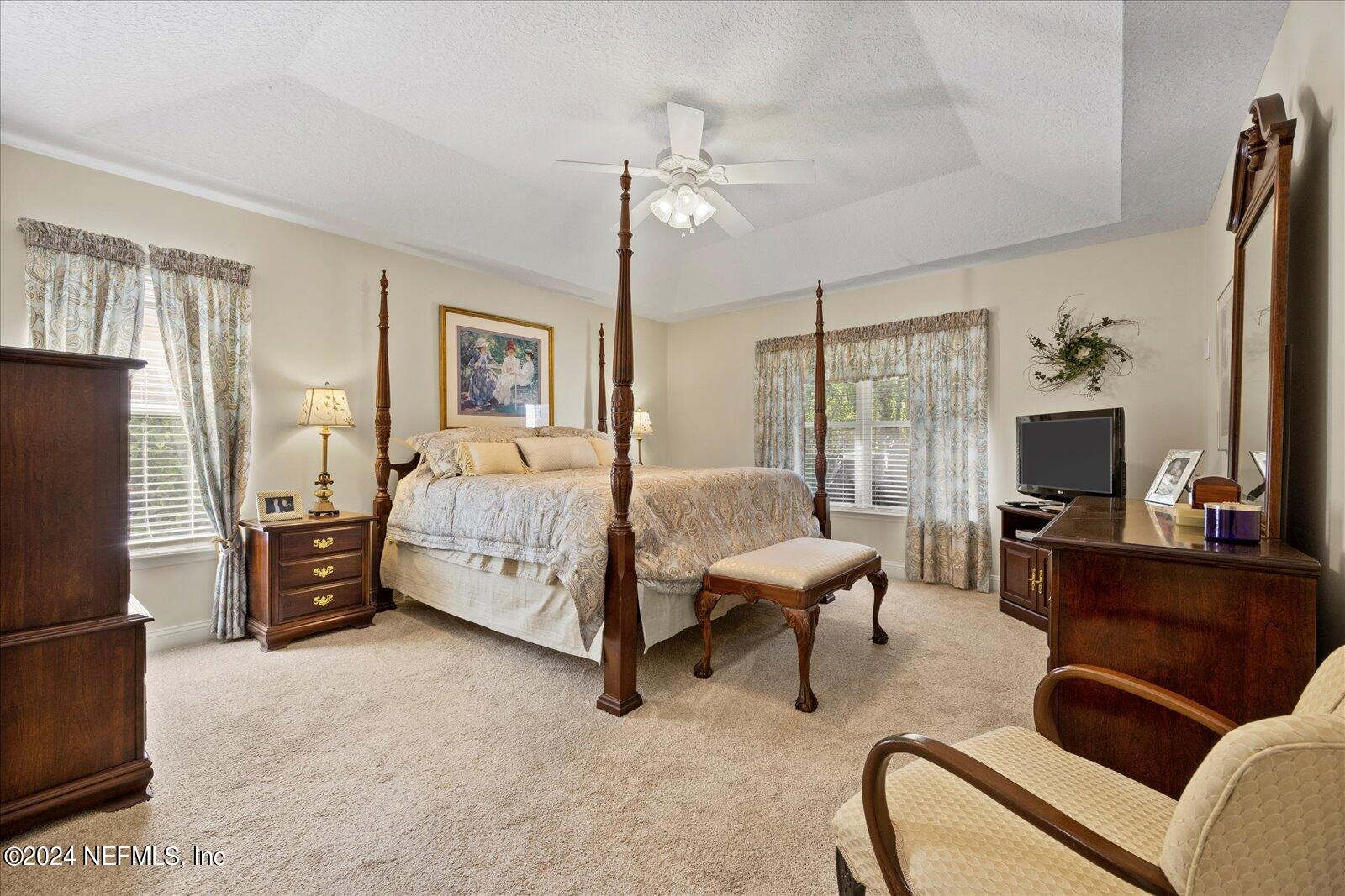 1283 Paradise Pond Road St. Augustine, FL 32092 - Photo 19 of 47 a bedroom with furniture and a flat screen tv