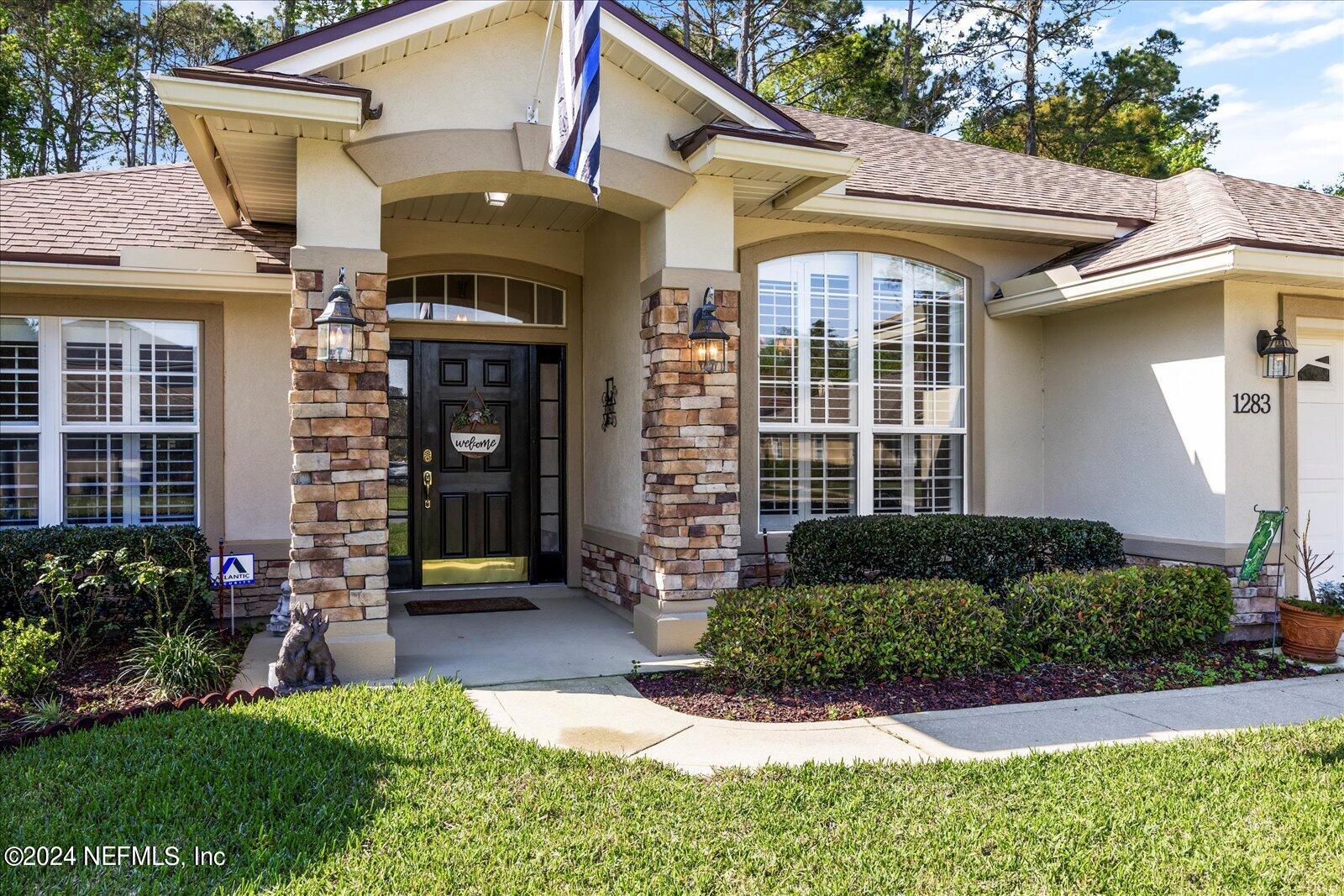 1283 Paradise Pond Road St. Augustine, FL 32092 - Photo 2 of 47 a front view of a house with a yard