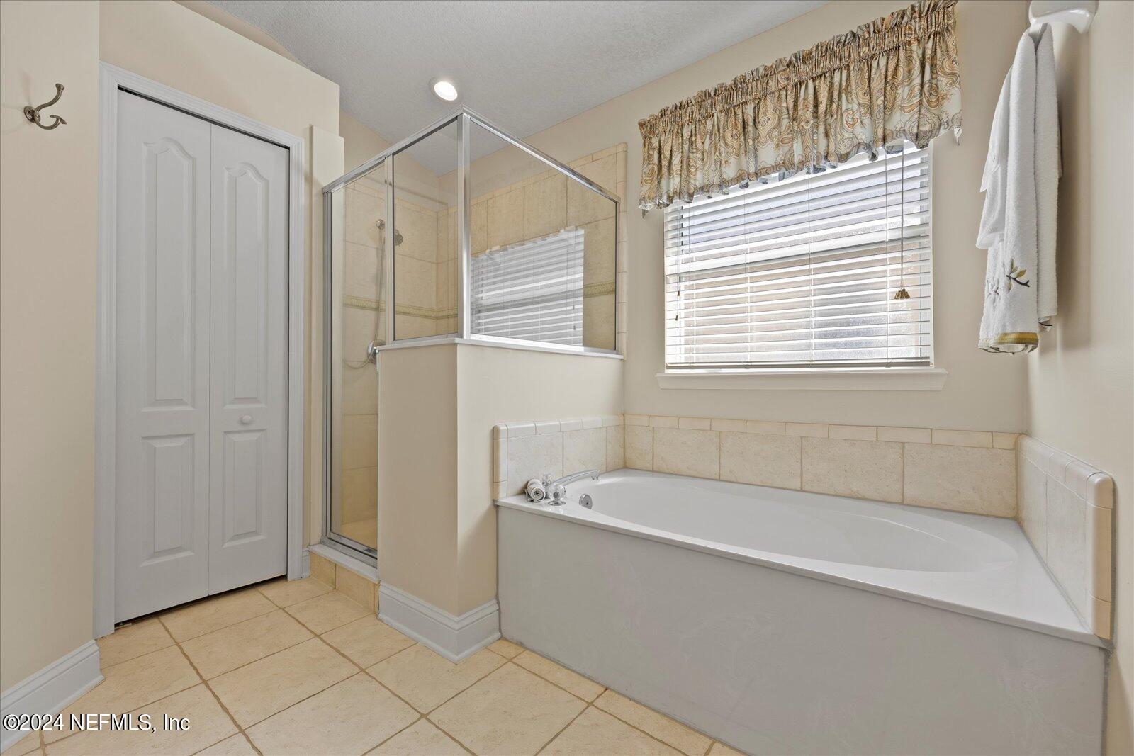 1283 Paradise Pond Road St. Augustine, FL 32092 - Photo 23 of 47 a bathroom with a bathtub and a shower