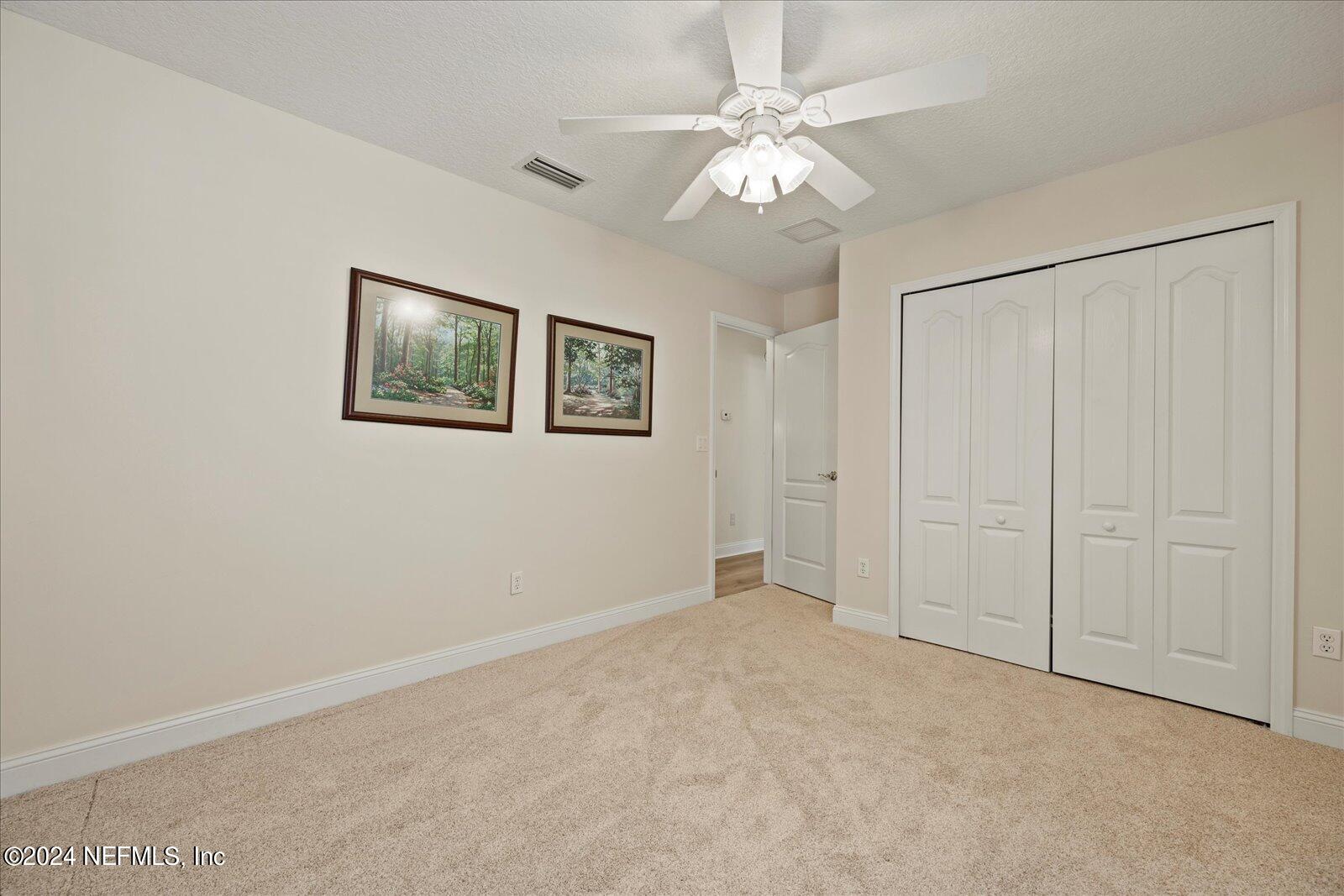 1283 Paradise Pond Road St. Augustine, FL 32092 - Photo 29 of 47 an empty room with chandelier fan