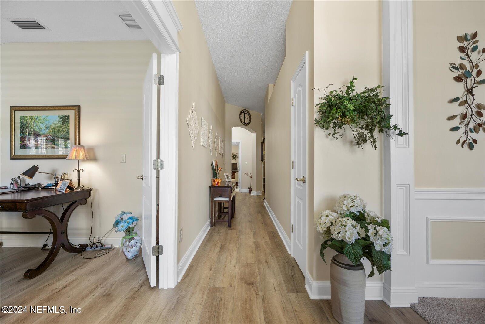 1283 Paradise Pond Road St. Augustine, FL 32092 - Photo 3 of 47 a view of a hallway with wooden floor and a potted plant