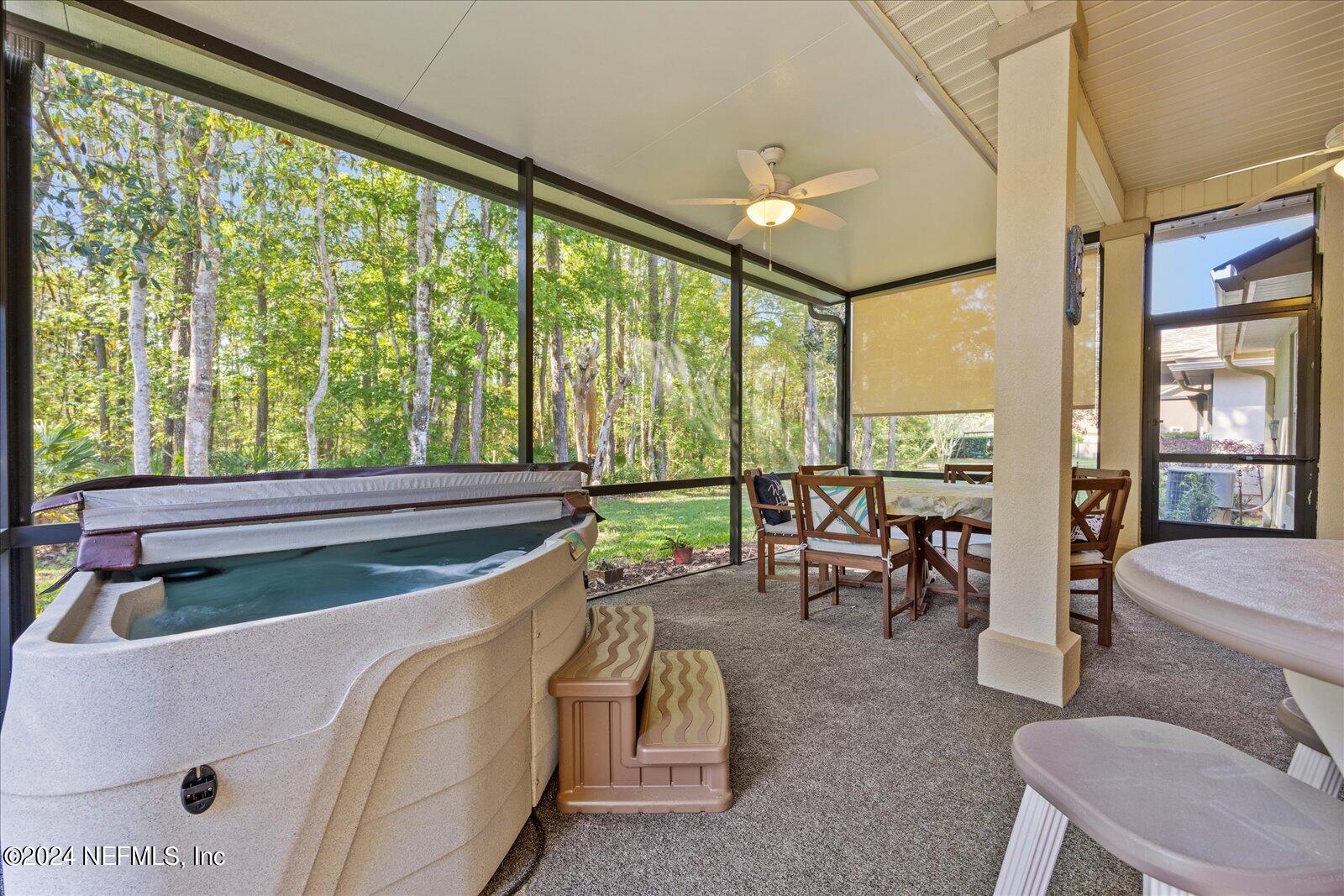 1283 Paradise Pond Road St. Augustine, FL 32092 - Photo 31 of 47 a living room with furniture and a floor to ceiling window