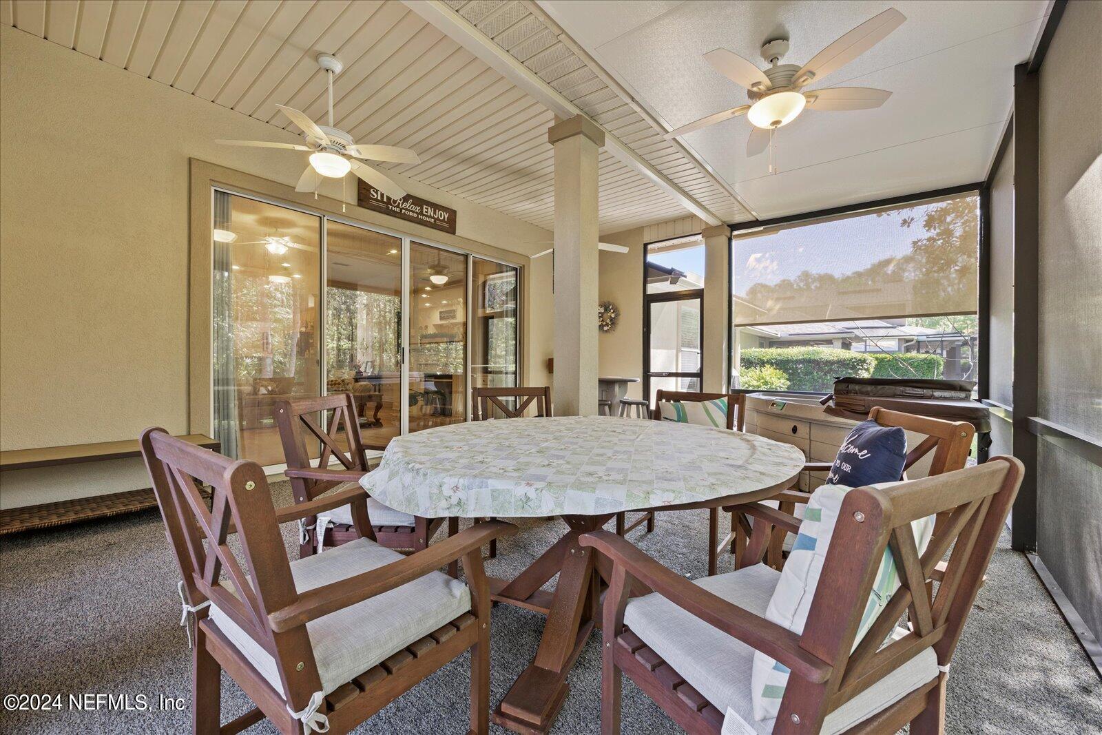 1283 Paradise Pond Road St. Augustine, FL 32092 - Photo 32 of 47 a dining room with furniture a chandelier and wooden floor